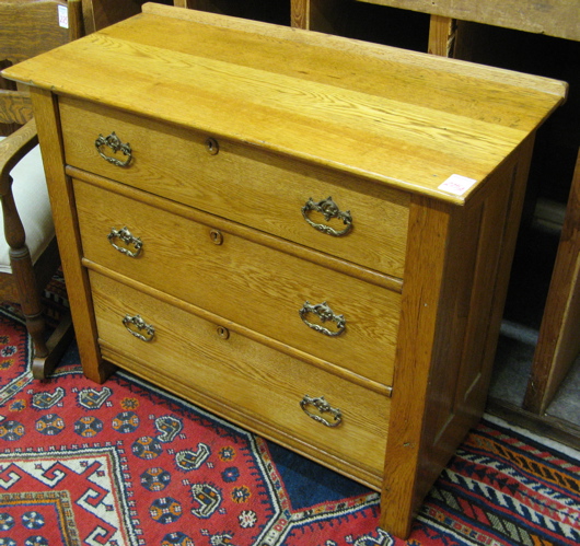 Appraisal: GOLDEN OAK CHEST OF DRAWERS American c having three large