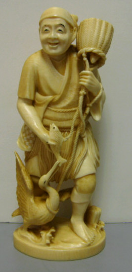 Appraisal: JAPANESE CARVED IVORY FIGURE OF A MAN Feeding a crane