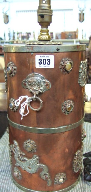 Appraisal: A copper cylindrical lamp base decorated with applied Chinese metal