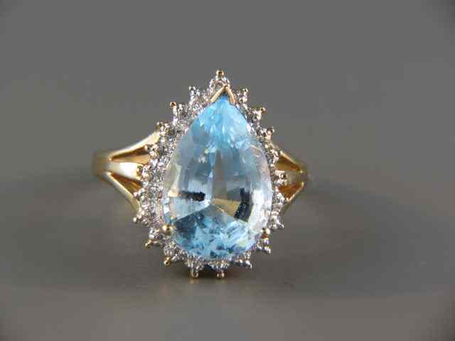 Appraisal: Blue Topaz Diamond Ring vivid carat pear shaped gem surrounded