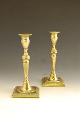 Appraisal: A pair of George III brass candlesticks each with a