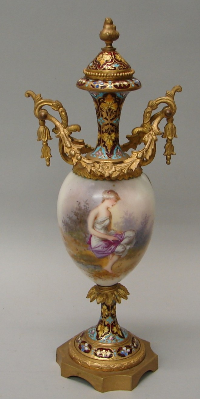 Appraisal: Double handle urn features classical woman seated in landscape champleve