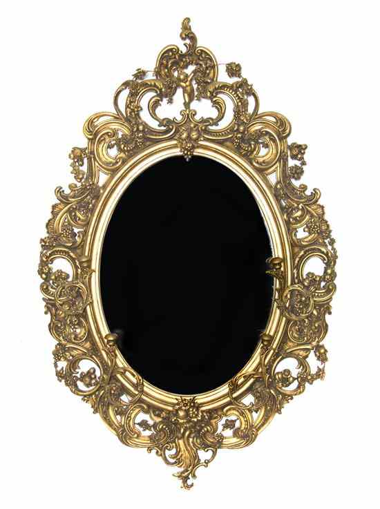 Appraisal: A French Giltwood Mirror of oval form the crest centered