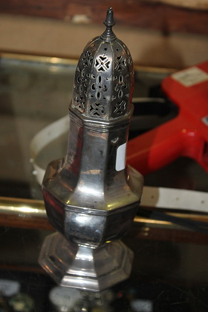 Appraisal: A GEORGIAN STYLE SILVER CASTER of octagonal baluster form on