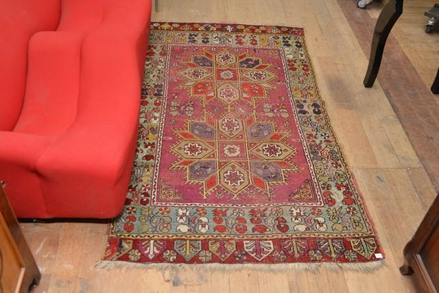 Appraisal: A TURKISH RUG IN RED AND TURQOUISE TONES