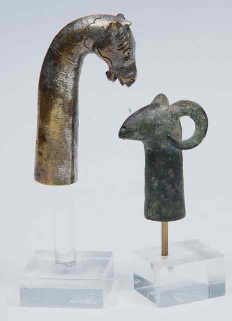 Appraisal: TWO EARLY EASTERN BRONZE ANIMAL FORM FINIALS one a horned