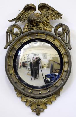 Appraisal: A REGENCY GILT WOOD CONVEX MIRROR the moulded cavetto frame