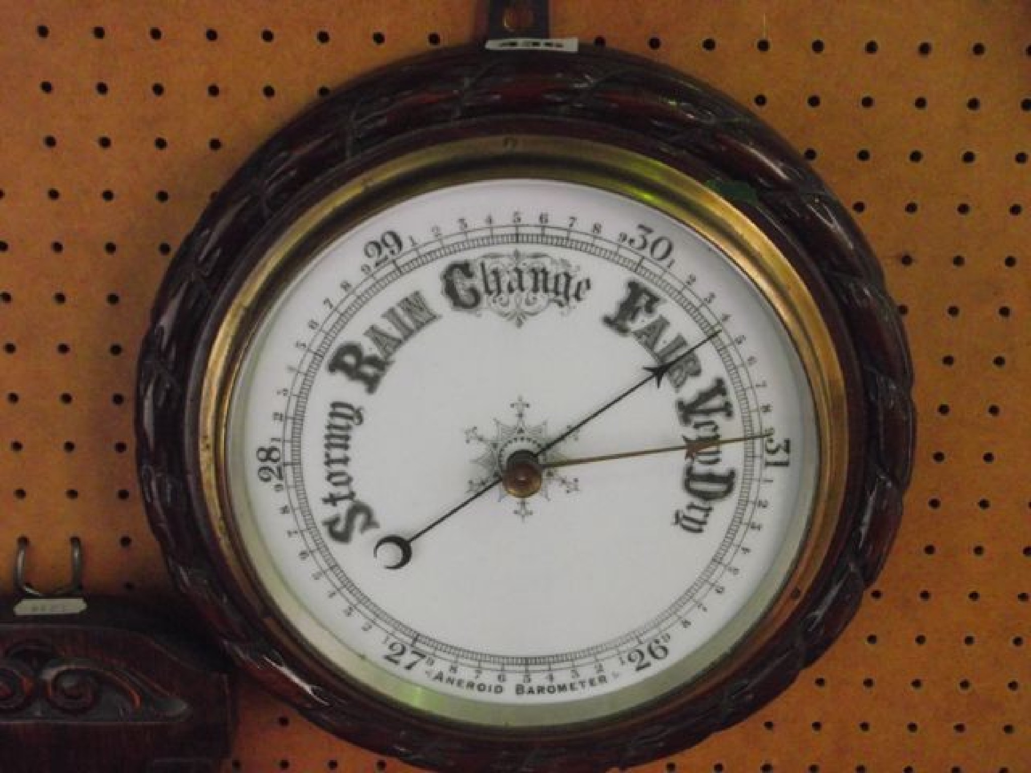 Appraisal: An Edwardian aneroid barometer the circular case with carved rope