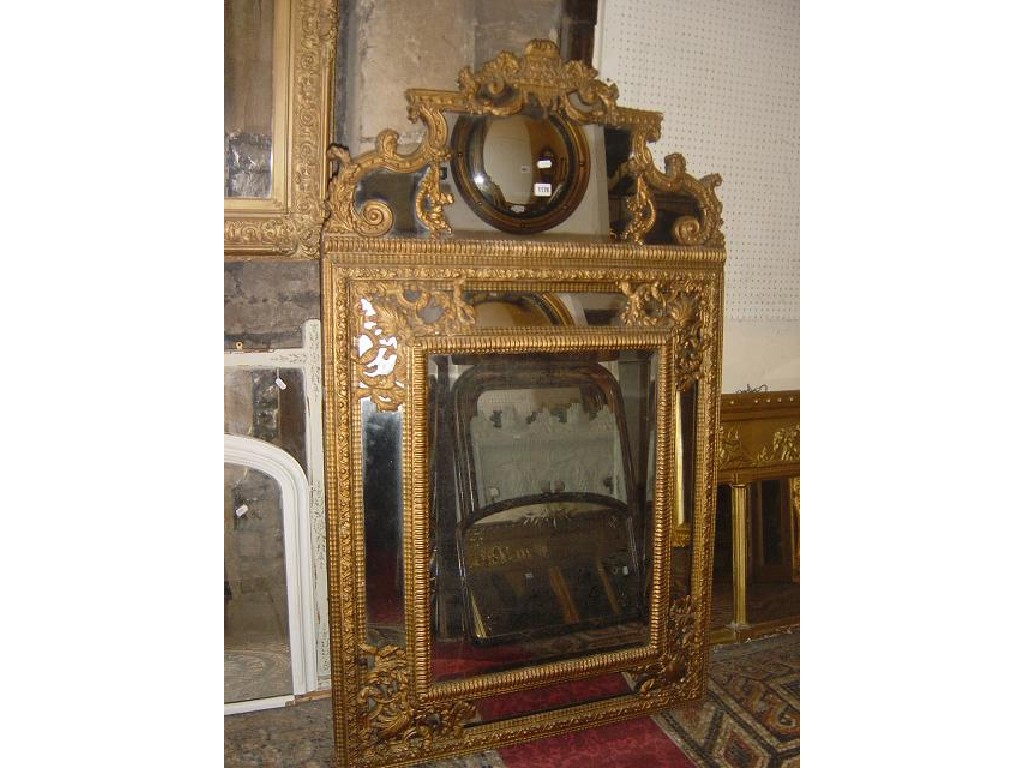 Appraisal: A substantial th century wall mirror with embossed brass frame