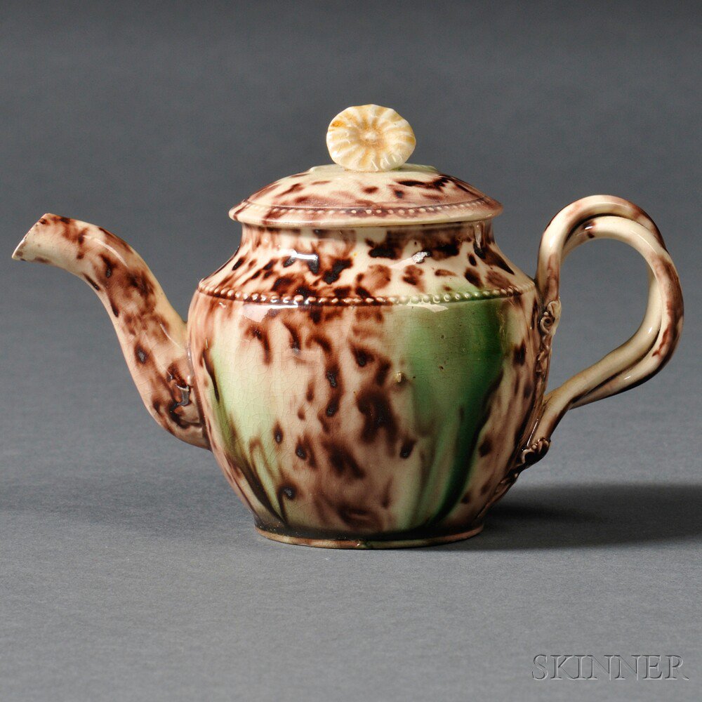 Appraisal: Staffordshire Cream-colored Earthenware Teapot and Cover England c entwined strap