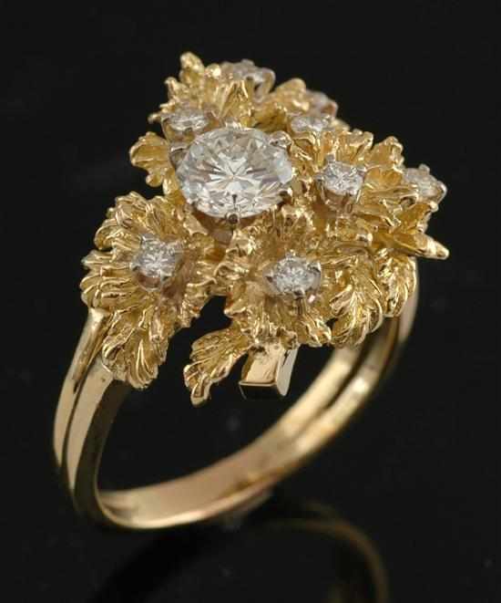 Appraisal: A diamond cocktail ring Comprising a principle round brilliant cut