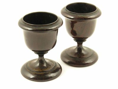 Appraisal: A pair of early th century turned rosewood egg cups