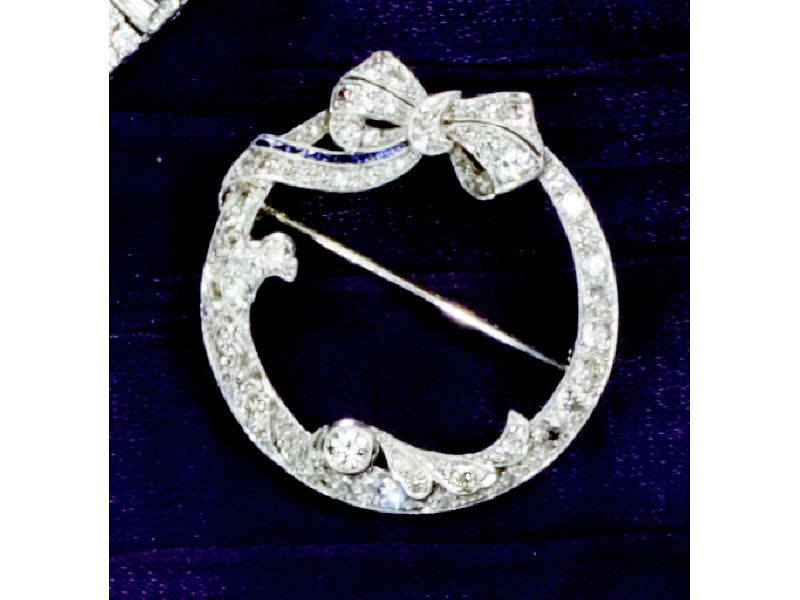 Appraisal: DIAMOND BROOCH Platinum circle design with bow trim set with