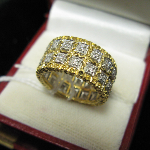 Appraisal: DIAMOND AND EIGHTEEN KARAT WHITE AND YELLOW GOLD BAND The