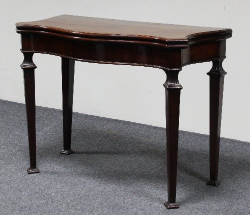 Appraisal: A George III mahogany serpentine card table on square tapering