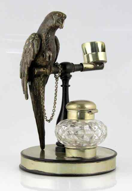 Appraisal: A Continental silver plated inkstand with parrot on perch taper