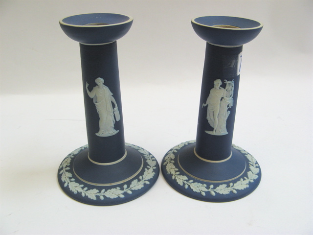 Appraisal: PAIR BLUE JASPERWARE COLUMN CANDLEHOLDERS white classical relief figures on