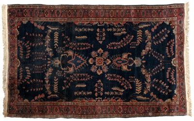 Appraisal: Sarouk rug repeating floral designs on dark blue field ft