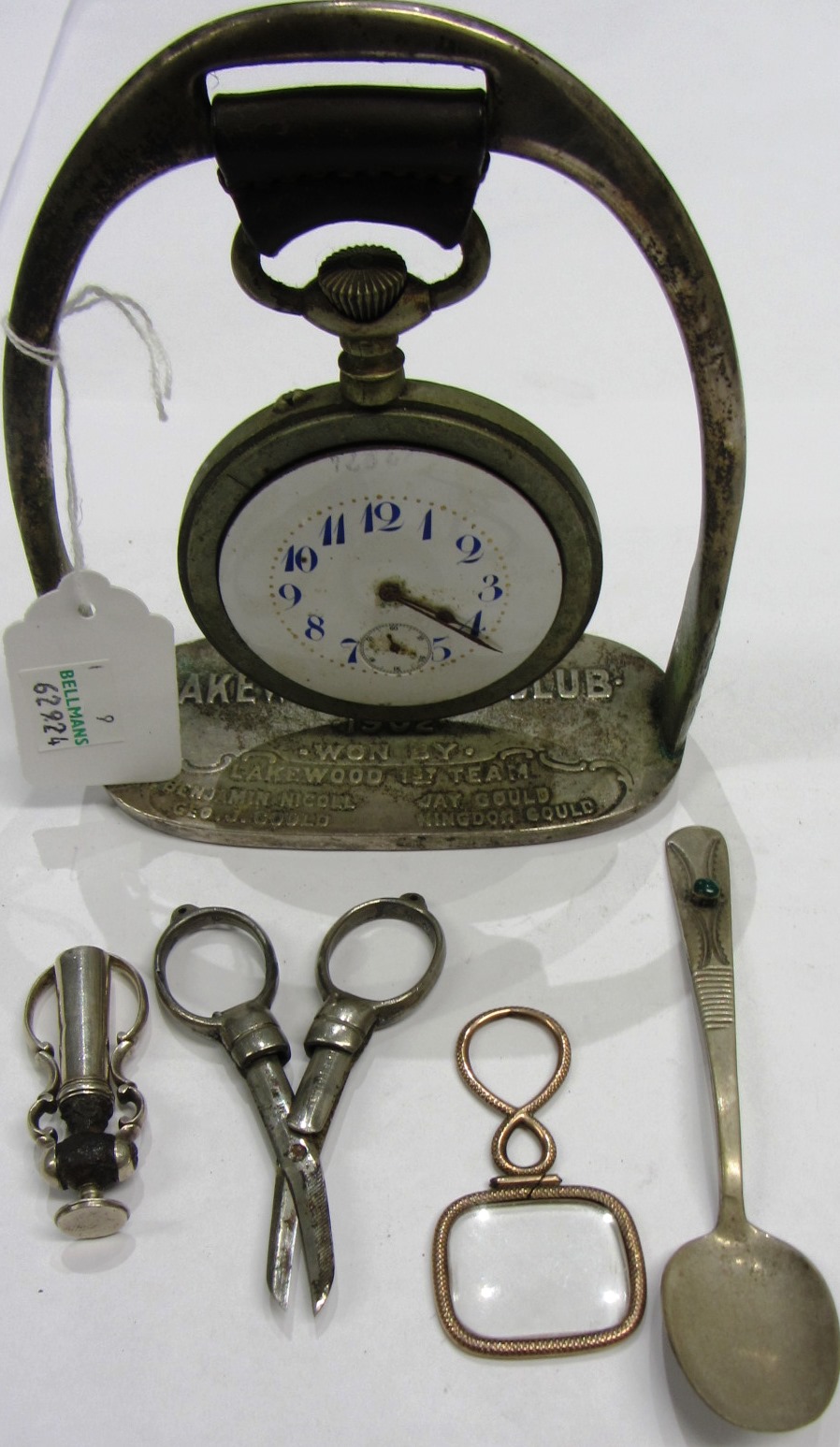 Appraisal: An openfaced travelling watch fitted to a stirrup shaped supporting