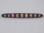 Appraisal: A carat gold opal and ruby brooch largest opal approx