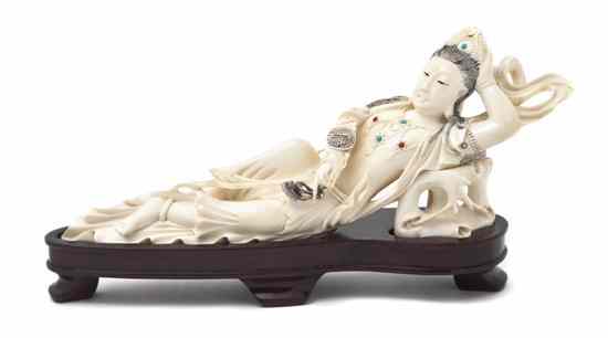 Appraisal: A Carved Chinese Ivory Figure depicting a recumbent lady having