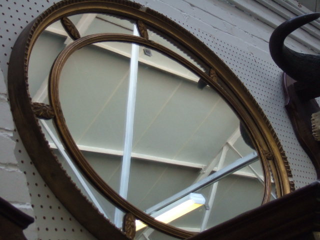 Appraisal: A th century gilt framed oval wall mirror of sectional