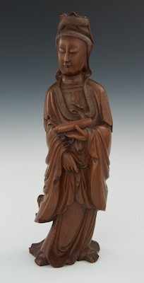 Appraisal: A Carved Wood Figure of a Quan Yin The grandly