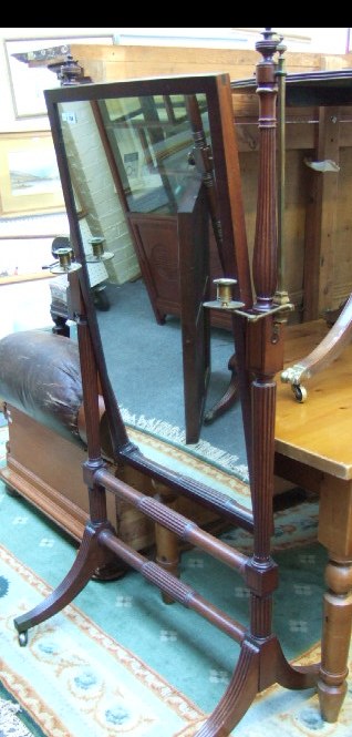 Appraisal: A Regency mahogany cheval mirror reeded baluster supports and downswept