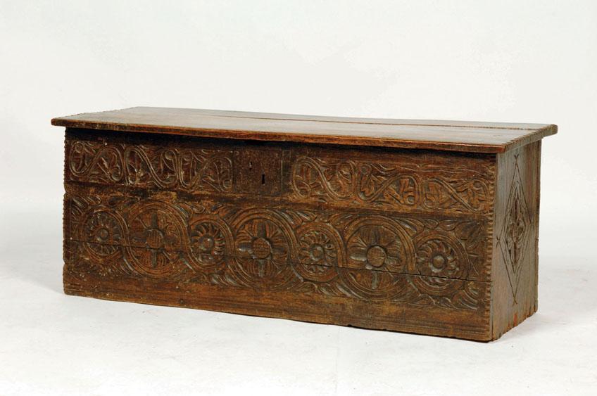 Appraisal: A STAINED OAK COFFER with a rectangular top and chip-carved