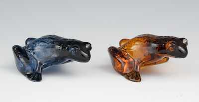 Appraisal: A Pair of Lalique Glass Frogs Charming amber and blue-grey