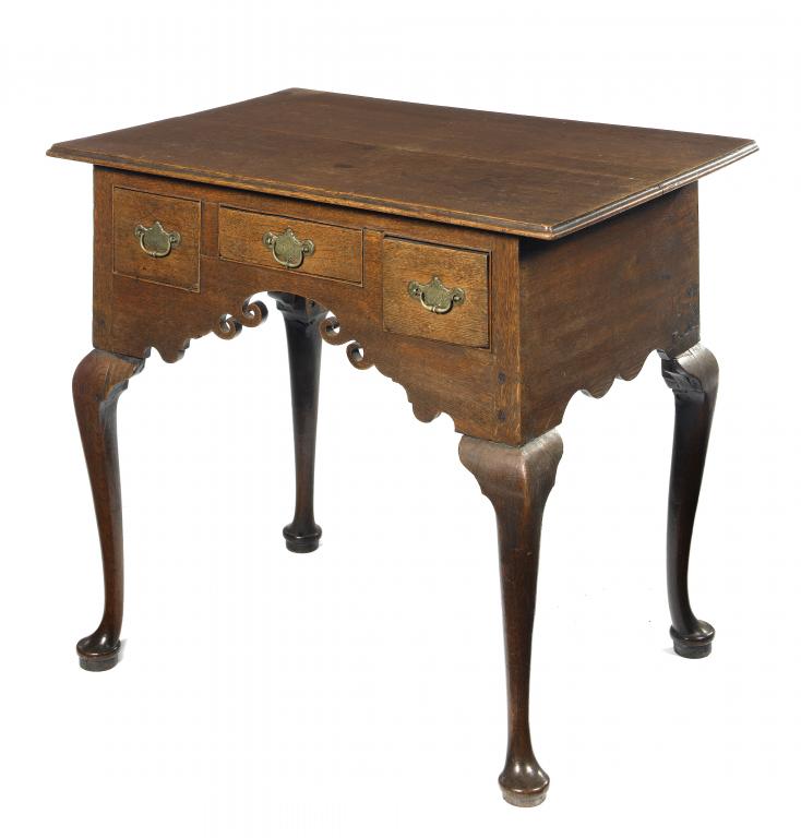 Appraisal: A GEORGE III OAK LOWBOY the scrolling apron fitted with