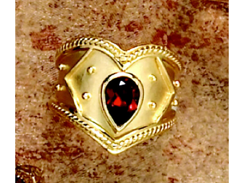 Appraisal: GARNET RING k yellow gold Etruscan style ring with one