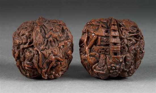 Appraisal: Pair of Chinese carved walnuts in the Ming manner figural