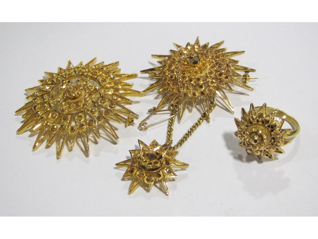 Appraisal: Two African gold Star of Mogadishu brooches and a similar