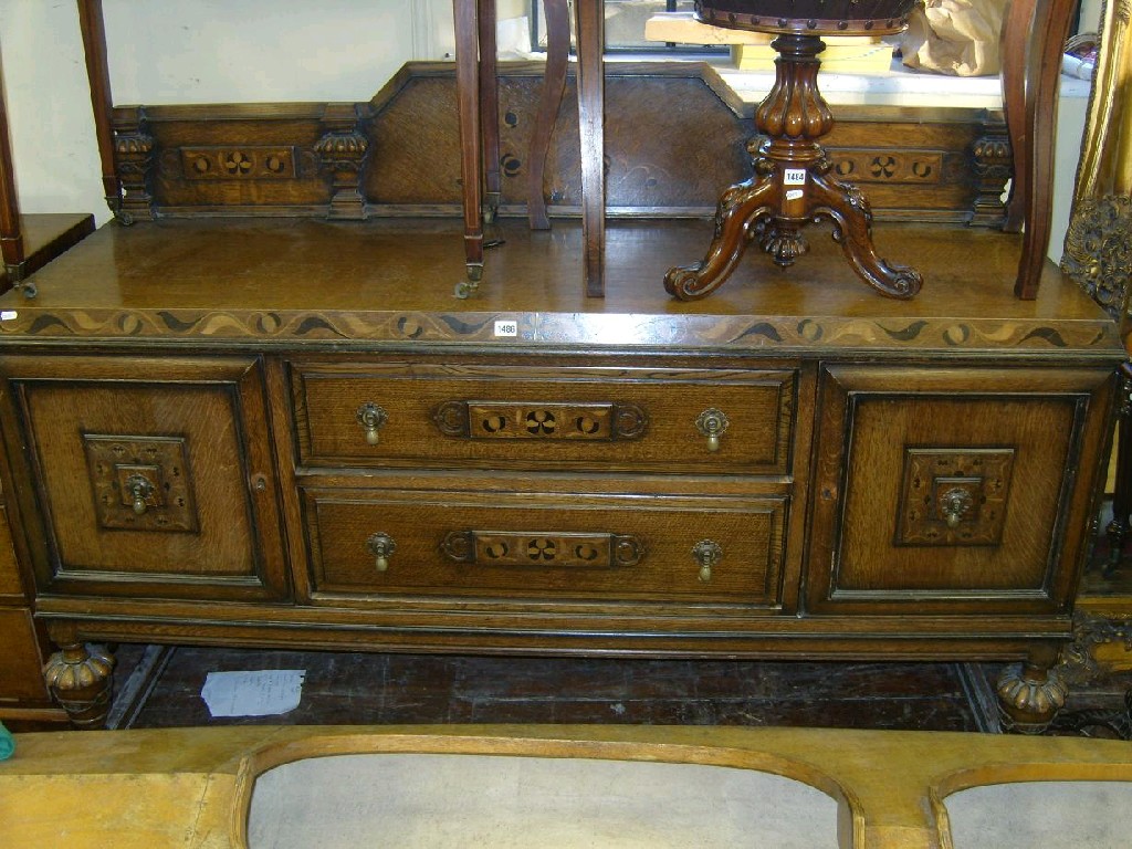 Appraisal: A 's Jacobean revival oak sideboard fitted with central frieze