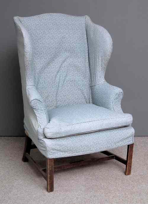 Appraisal: An th Century mahogany wing back easy chair upholstered in