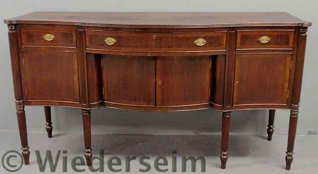 Appraisal: Sheraton style mahogany serpentine front sideboard with a reeded top