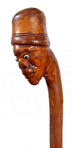 Appraisal: Carved man Folk-Art Cane Ca A carved one-piece shaft with