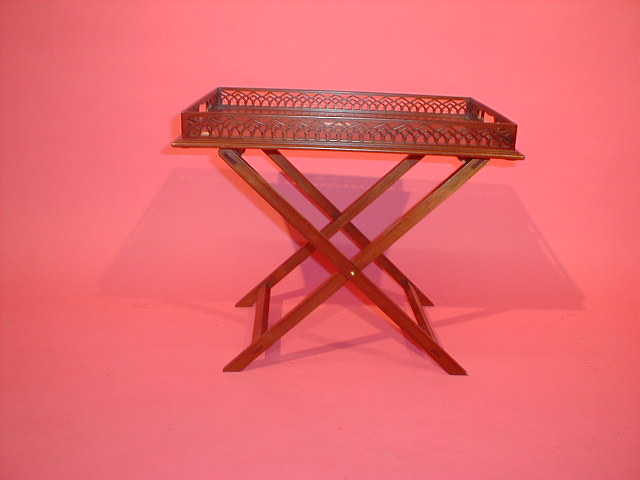 Appraisal: A reproduction mahogany fretwork butlers tray on folding stand