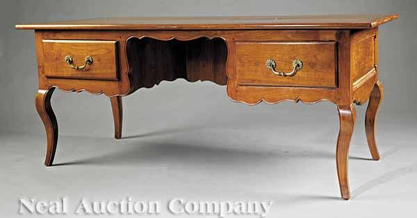 Appraisal: A Louis XV-Style Provincial Fruitwood Bureau Plat with a kneehole