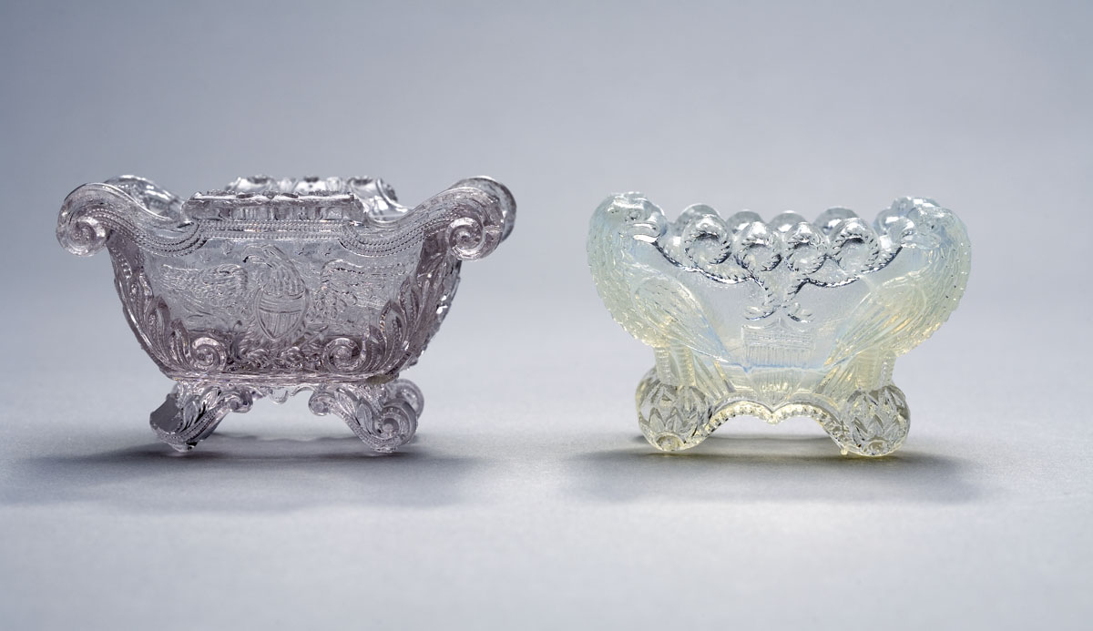 Appraisal: THREE LACY PRESSED COLORED AND COLORLESS 'EAGLE' PATTERN SALTS BOSTON