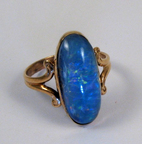 Appraisal: OPAL AND TEN KARAT GOLD RING set with an oval