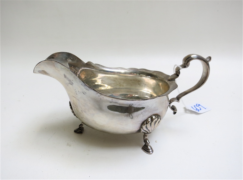 Appraisal: STERLING SILVER GRAVY BOAT by Ensko tri-footed with scalloped rim