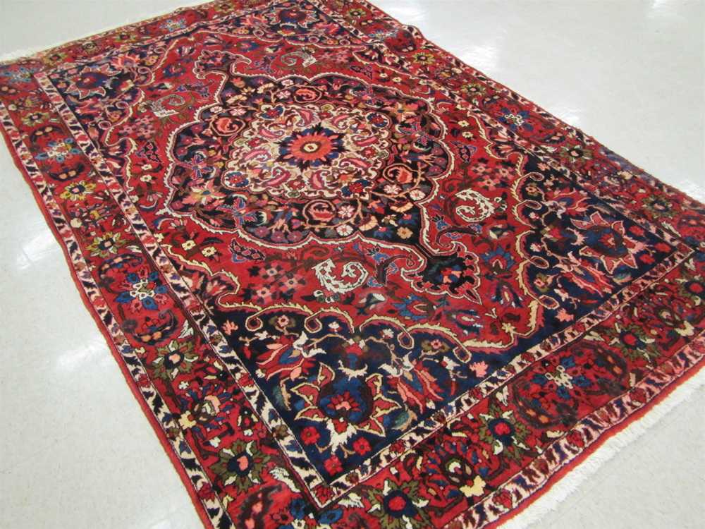 Appraisal: SEMI-ANTIQUE PERSIAN TRIBAL CARPET hand knotted in a large central