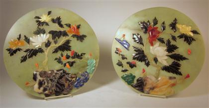 Appraisal: Pair of Chinese green stone and applied circular plaquesApplied with