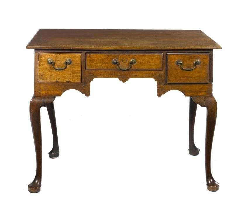 Appraisal: A GEORGE III OAK LOWBOY the moulded top with three