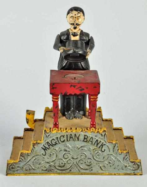 Appraisal: Cast Iron Magician Mechanical Bank Description Working Manufactured by J