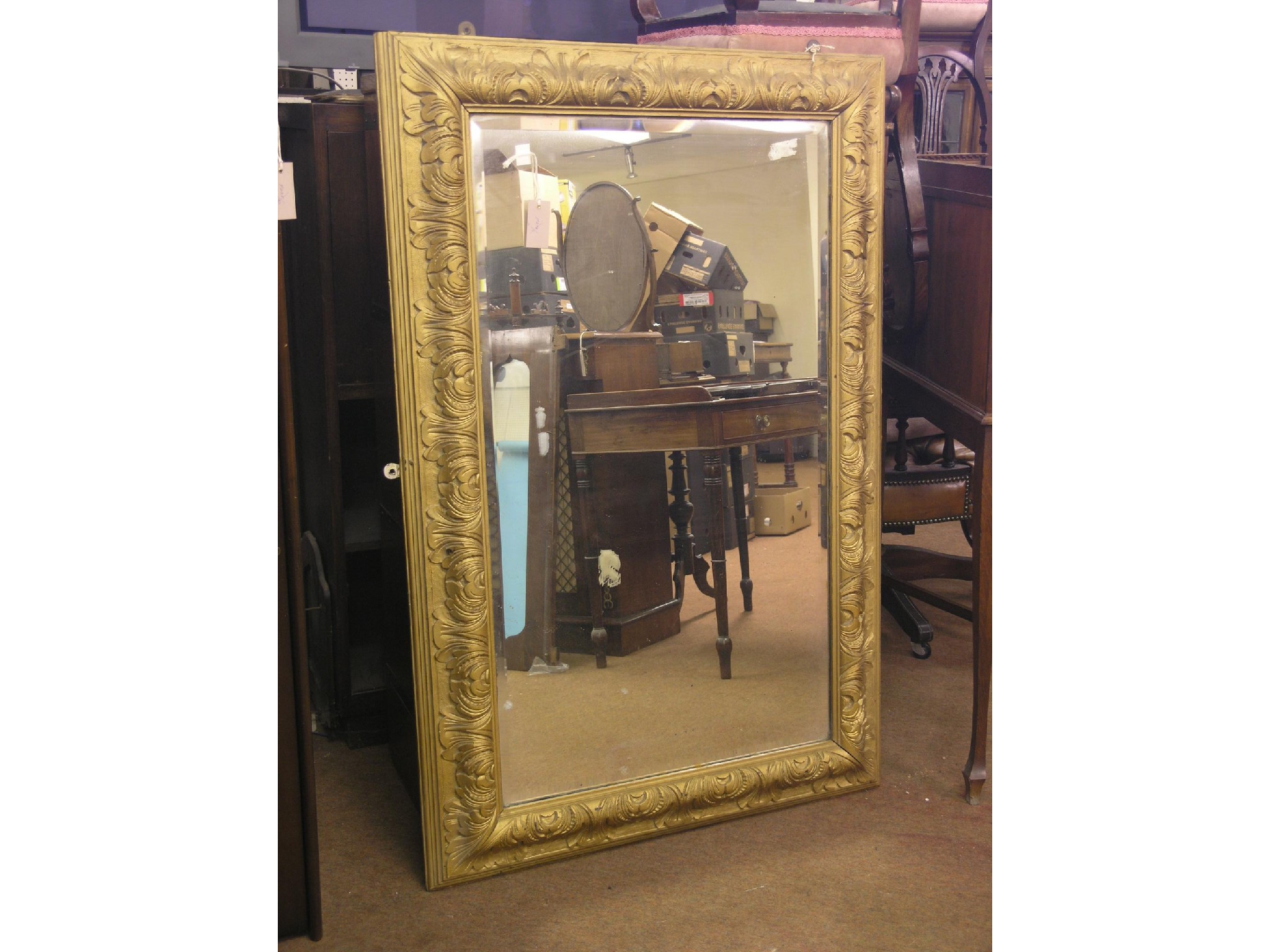 Appraisal: A large mirror rectangular-shape with bevelled plate within gilded frame