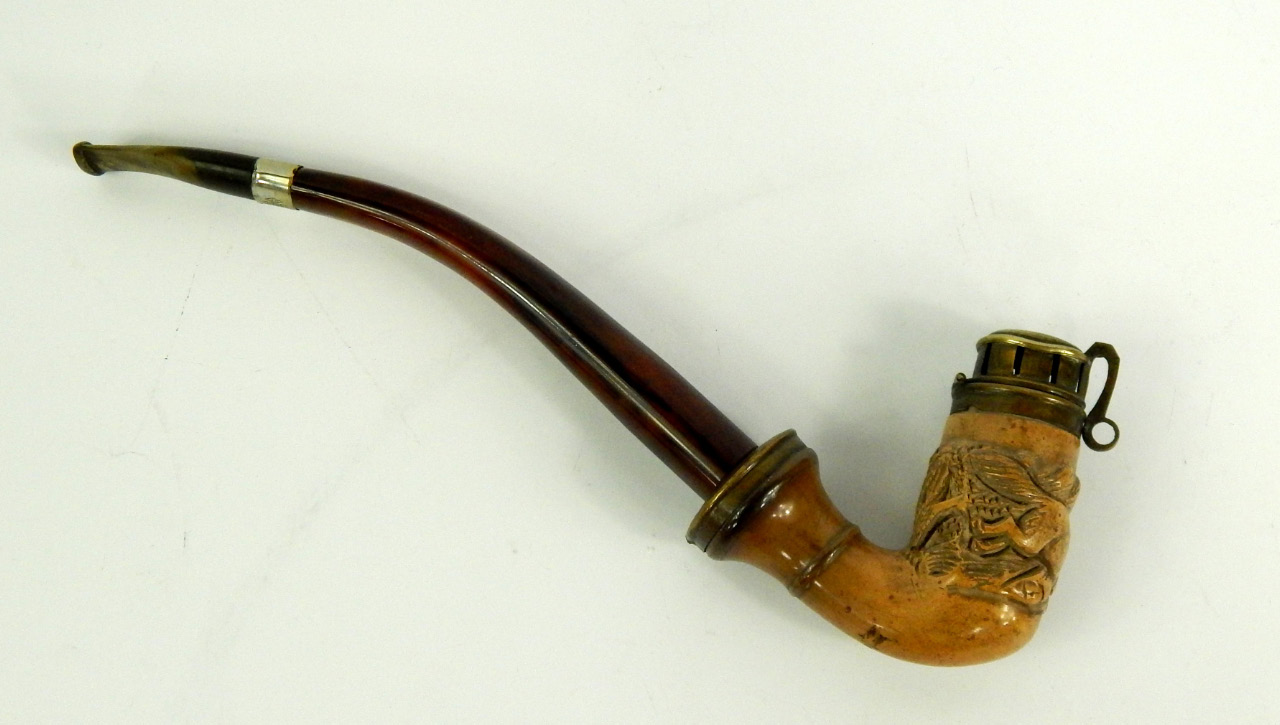 Appraisal: A Meerschaum pipe carved with a wolf in a forest