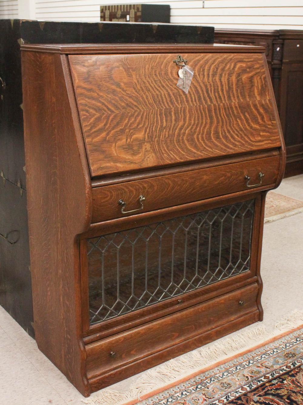 Appraisal: AN OAK SLANT-FRONT SECRETARY BOOKCASE American early th century the